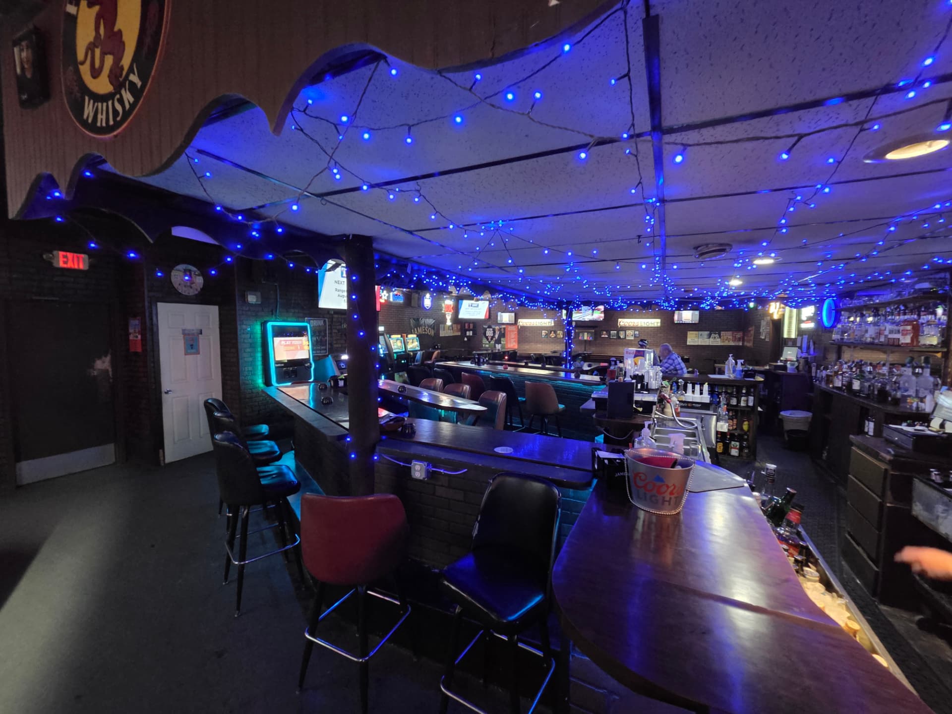 Blue Christmas lights strung across the whole ceiling above the bar